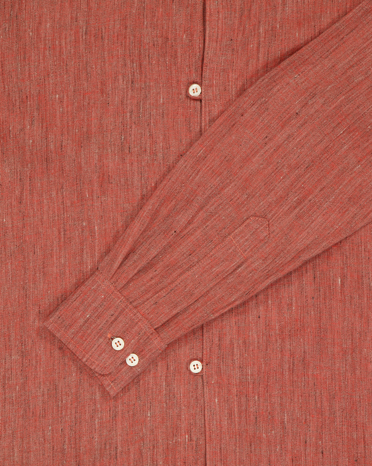 Close up of sleeve from a belgian linen terracota fabric. 
